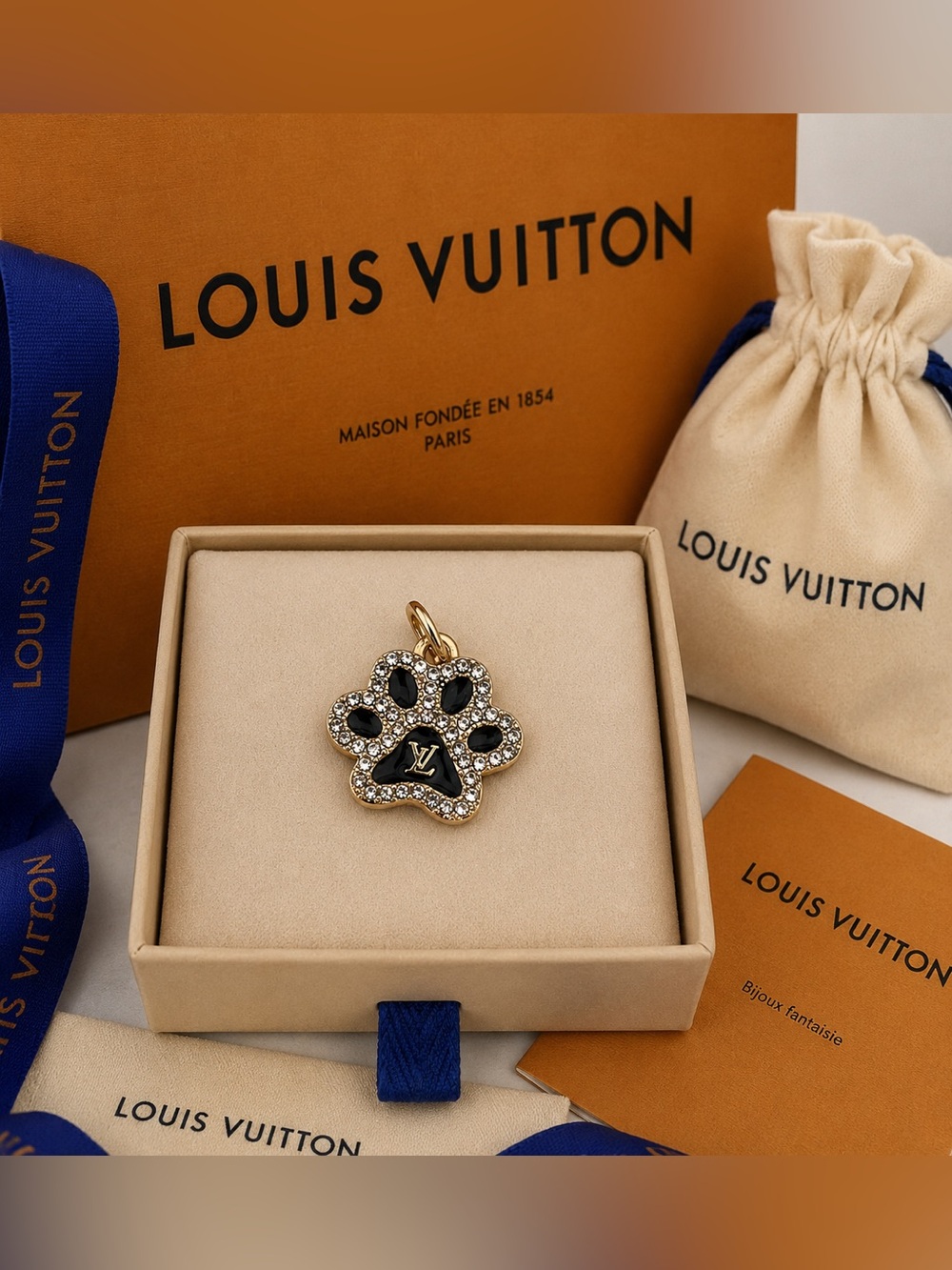 Louis Vuitton stamped Black and Gold tone Paw Print Charm with Crystals